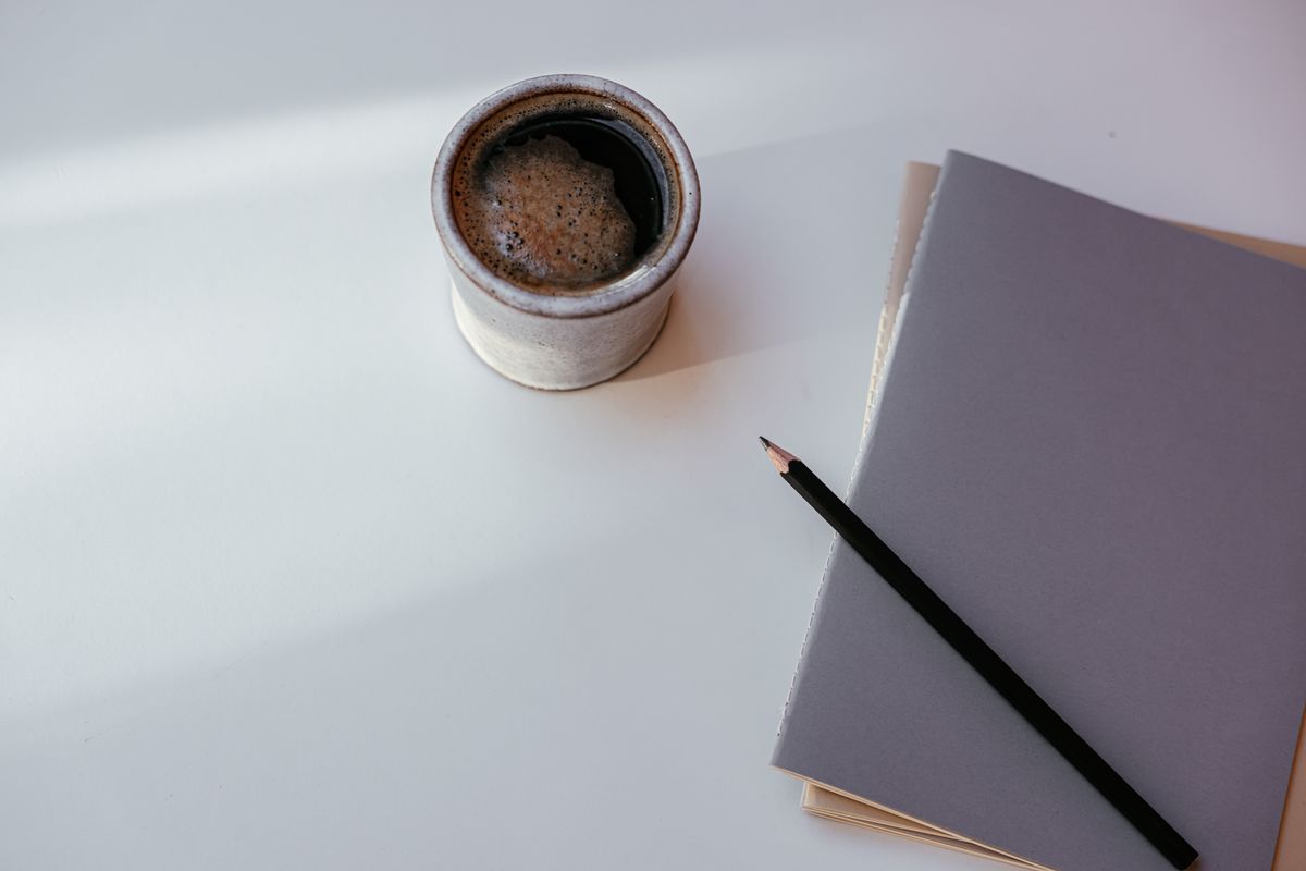 Notebooks and a cup of coffee on a desk, ready for planning